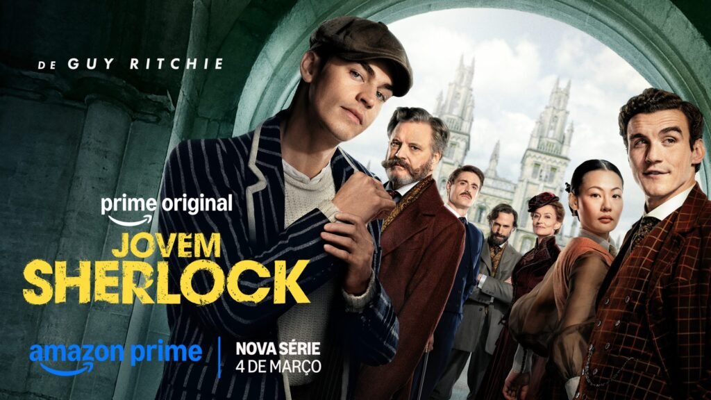 Poster oficial da série Jovem Sherlock no Prime Video mostrando o ator Hero Fiennes Tiffin em destaque, usando boina e blazer listrado, acompanhado pelo elenco principal com a arquitetura histórica de Oxford ao fundo.